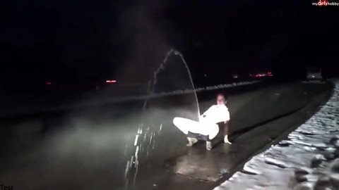 The girl pisses on the road