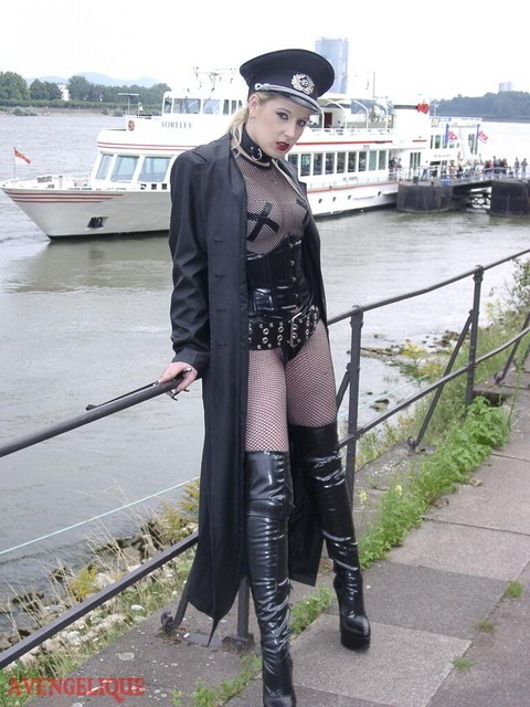 Solo model Avengelique poses in fetish wear alongside a waterway | Фото 15