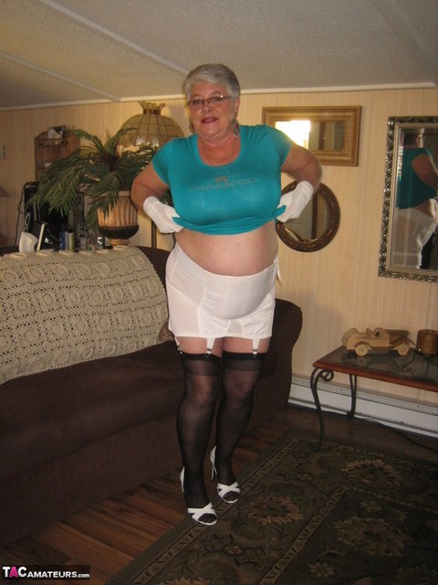 Fat Oma Girdle Goddess wears white gloves while disrobing to a bra and girdle | Фото 14