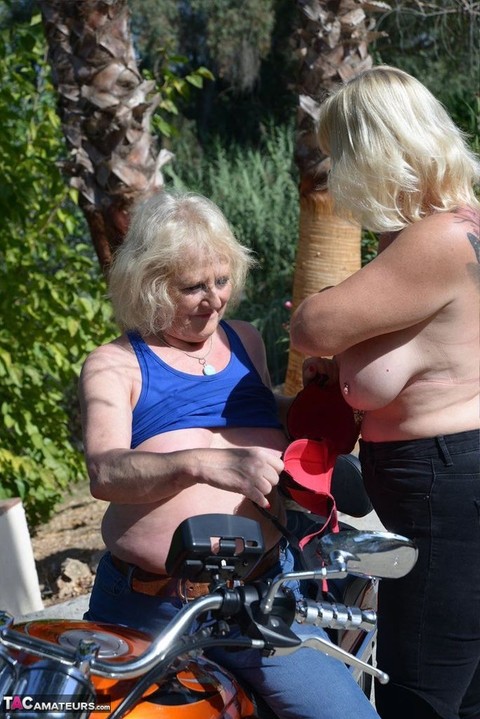 Older blonde lesbians go topless outdoors on a motorcycle | Фото 4