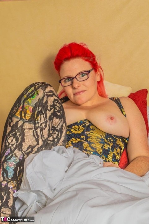 Amateur woman sports dyed hair and glasses while exposing her pierced pussy | Фото 7