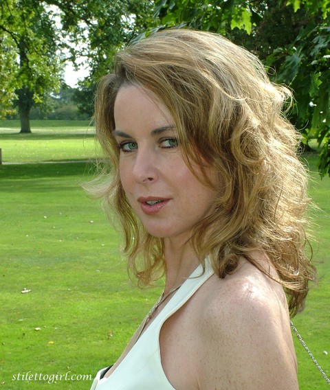 Clothed lady takes a rest on a park bench in a long skirt, hose and stilettos | Фото 8