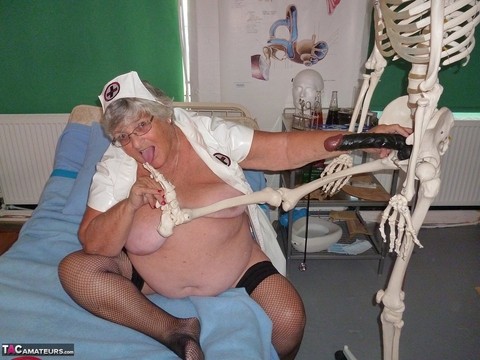 Fat old nurse Grandma Libby attaches a dildo to a skeleton for sexual relief