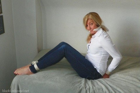 Blonde woman is cleave gagged and hogtied in a white blouse and blue jeans | Фото 6