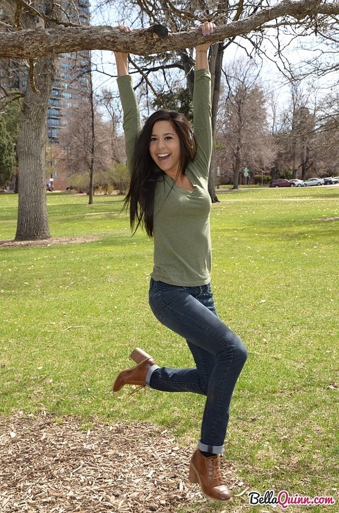 Latina chick Bella Quinn climbs a tree in the park wearing a sweater and jeans | Фото 12