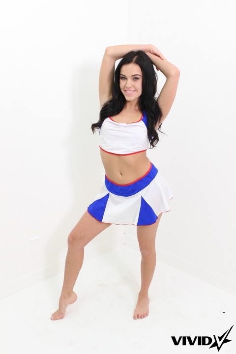 Dark-haired cheerleader Megan Rain works her phat ass while getting naked | Фото 1