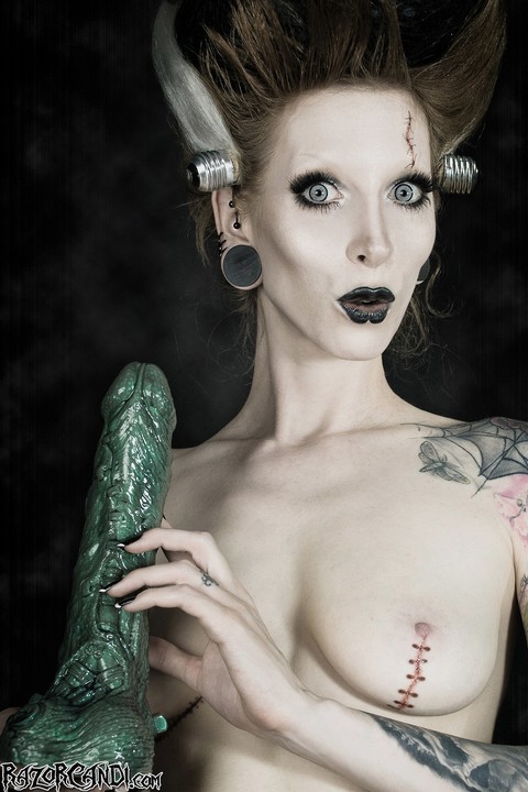 Tattoo model Razor Candi sucks on a big dildo in Bride of Frankenstein attire