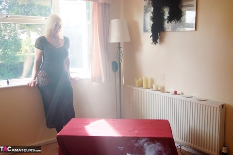 Blonde amateur Melody unleashes her large boobs near an open window | Фото 1