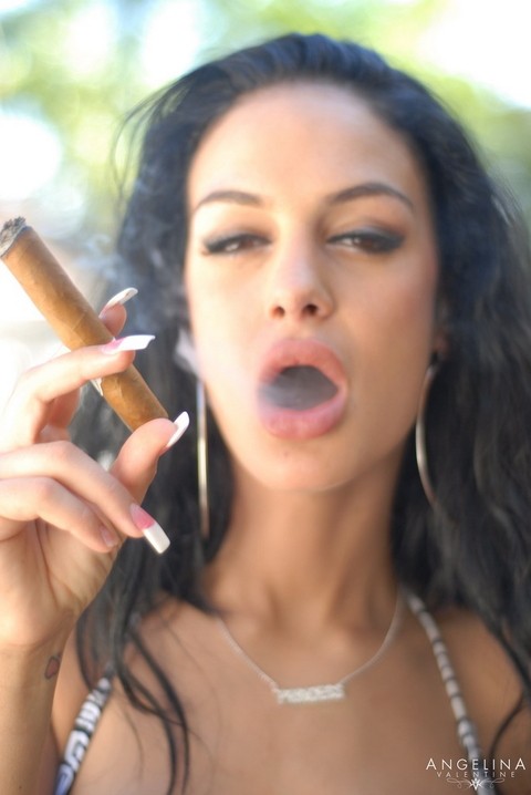 Alluring brunette chick Angelina Valentine goes topless while smoking a cigar | Фото 11