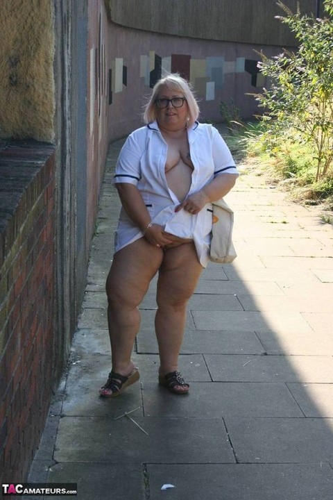 Fat older nurse Lexie Cummings exposes herself while walking on a sidewalk | Фото 9