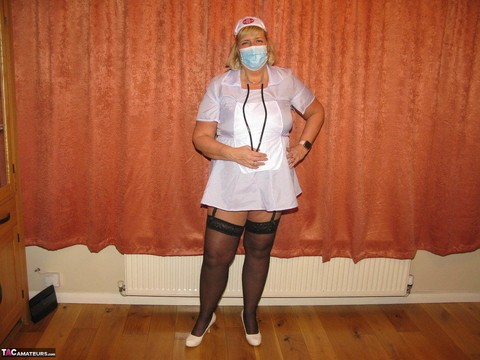 Fat nurse Chrissy Uk removes a surgical mask and uniform to model lingerie | Фото 2