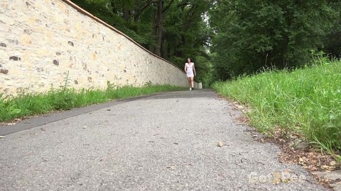 Caucasian female Lara Fox hikes up her dress to pee on a paved walking path | Фото 1