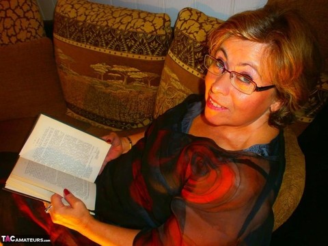 Aged amateur Caro pulls out her large breasts while reading a book in glasses