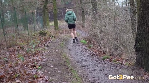 White girl Ali Bordeaux squats for a piss against a fence in a winter coat | Фото 15