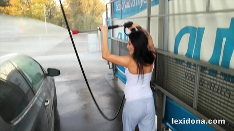 Pregnant girl Lexi Dona shows her belly bump while washing her car