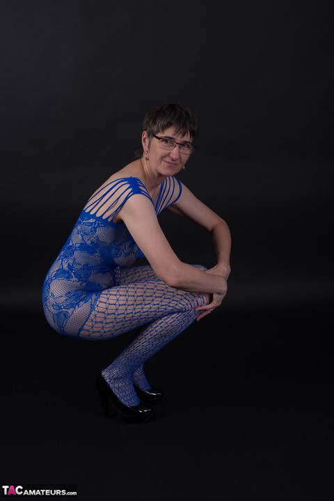 Older model poses in a crotchless bodystocking and heels with her glasses on | Фото 5