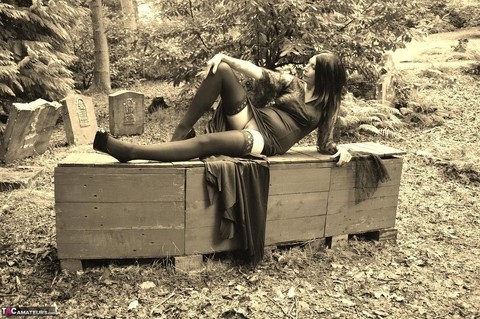 Goth girl Barby Slut bares her big tits and twat atop a casket in the woods | Фото 9