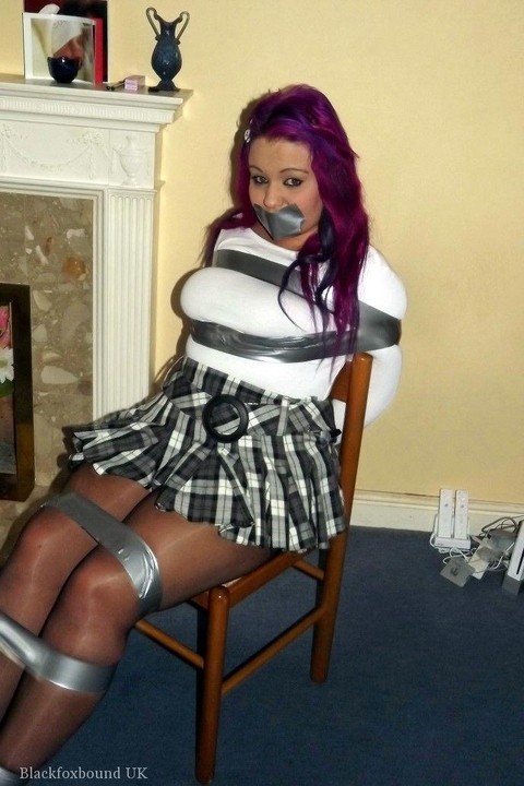 Busty girl with pink hair finds herself gagged and restrained to a chair | Фото 3