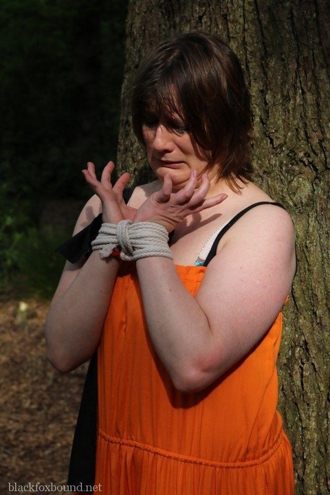 Fat female is gagged and tied to a tree in the woods with her clothes on | Фото 1