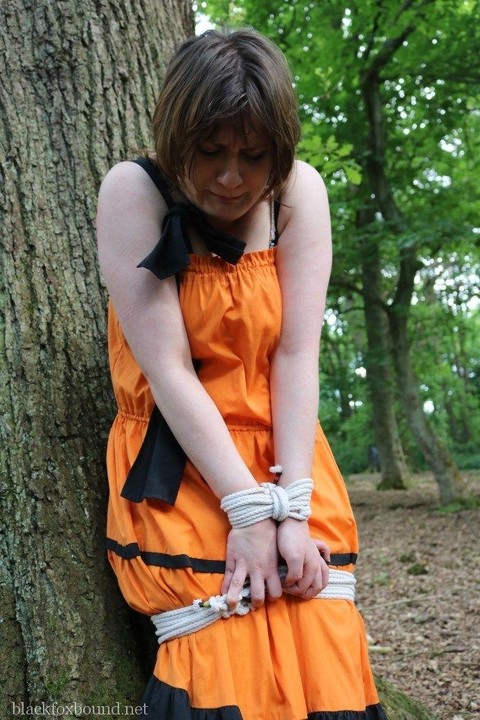 Fat female is gagged and tied to a tree in the woods with her clothes on | Фото 2