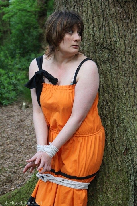 Fat female is gagged and tied to a tree in the woods with her clothes on | Фото 4