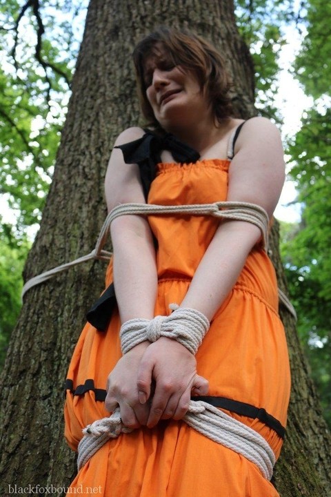 Fat female is gagged and tied to a tree in the woods with her clothes on | Фото 6