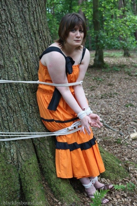 Fat female is gagged and tied to a tree in the woods with her clothes on | Фото 9