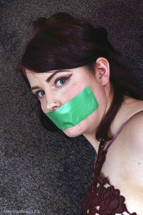 Clothed girl is silenced with a strip of tape over her mouth while tied up | Фото 7