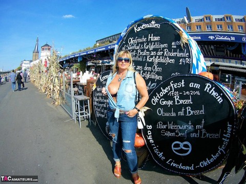 Thick blonde serves beer with big boobs out after putting in wood in the nude