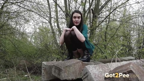 Brunette girl Lara pees on concrete blocks while walking railway tracks | Фото 4