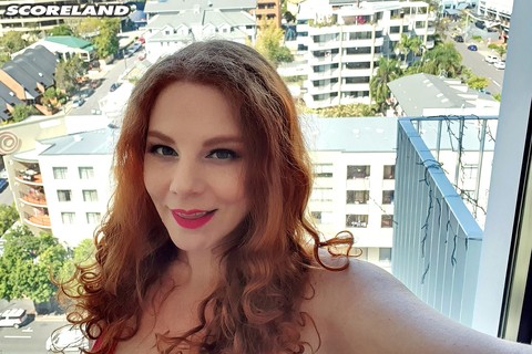 Chubby redhead Avalon sets her knockers free of a sports bra in pink hosiery | Фото 1