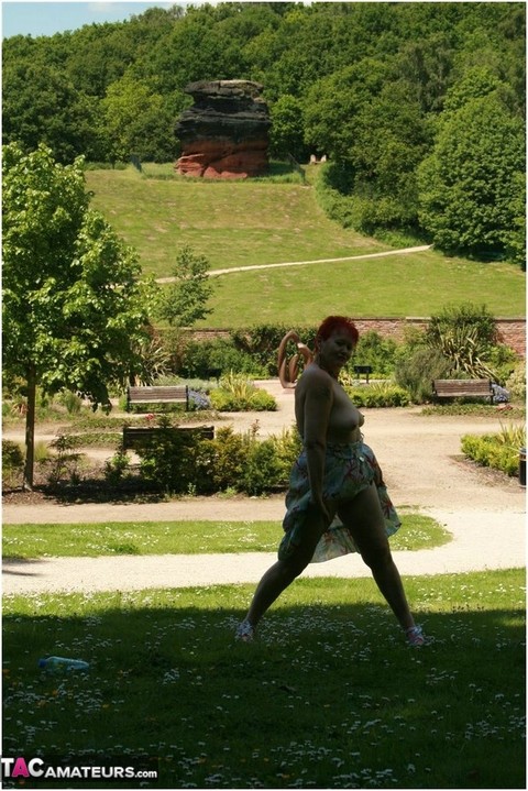 Older redhead Valgasmic Exposed gets totally naked in a public park | Фото 17