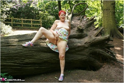 Older redhead Valgasmic Exposed gets totally naked in a public park | Фото 20