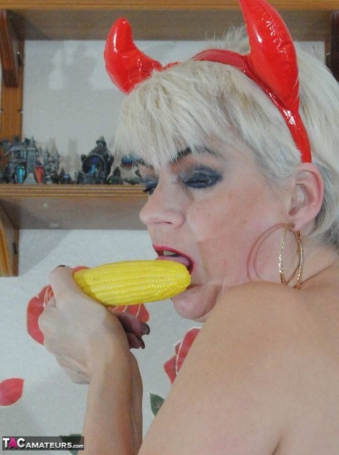 Devilish older blonde Dimonty masturbates with a corncob vibrator in OTK boots | Фото 12