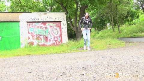 Solo girl with black hair squats for a piss on the side of a dirt road | Фото 1