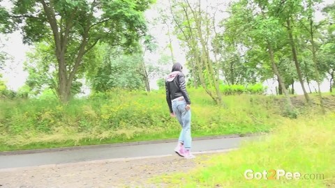 Solo girl with black hair squats for a piss on the side of a dirt road | Фото 15