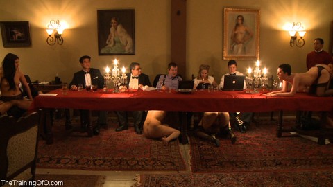 Female slaves treating the house guests to kinky under the table oral action