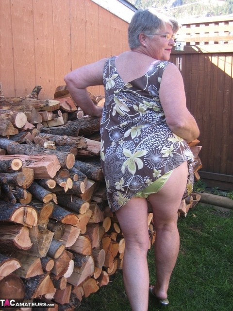 Brazen older granny strips off by the wood pile to show off BBW tits & big ass