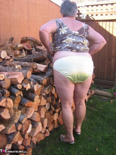 Brazen older granny strips off by the wood pile to show off BBW tits & big ass | Фото 8