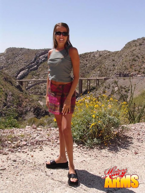 Amateur model Lori Anderson poses high up in the hills in just her sunglasses