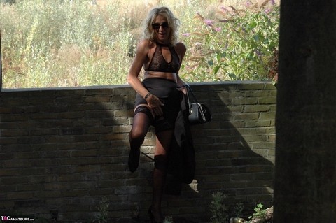 Mature blonde Kyras Nylons models stiletto heels in hosiery and a black skirt | Фото 15