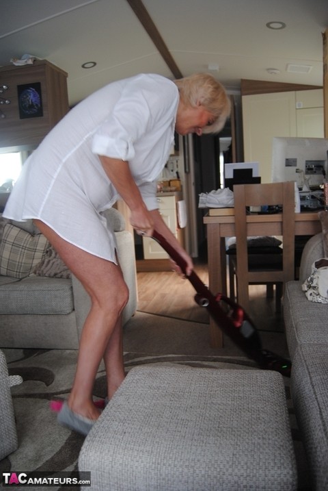 Hot older woman Dimonty sports a no panty up skirt while vacuuming | Фото 9