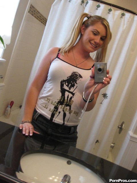 Blonde gf Hayden Night snaps selfies in bathroom while licking a lollipop