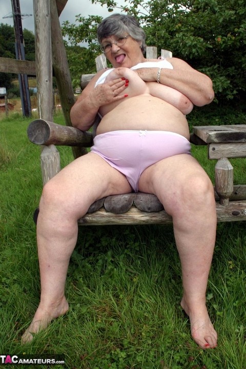 Old British woman Grandma Libby exposes her boobs on a backyard bench swing | Фото 12