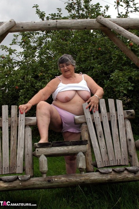 Old British woman Grandma Libby exposes her boobs on a backyard bench swing | Фото 18