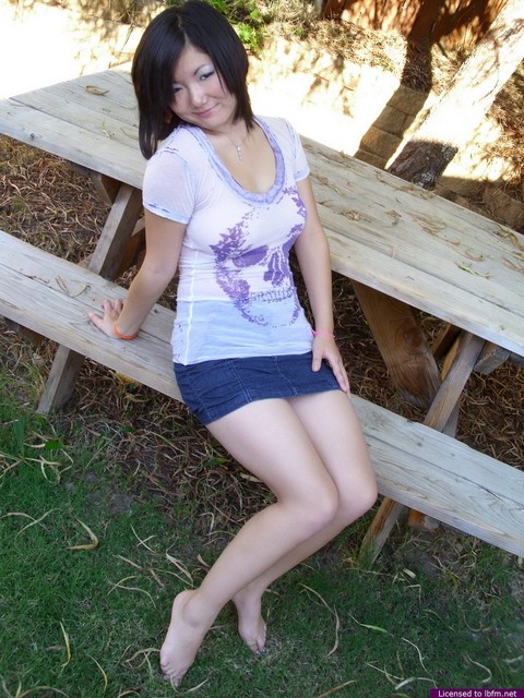 Busty Asian amateur shows the pink of her teen pussy on a picnic table | Фото 1