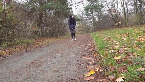 Brunette chick Helen takes a piss on a gravel path during a walk in the woods | Фото 1