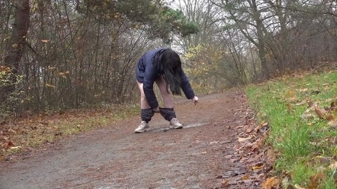 Brunette chick Helen takes a piss on a gravel path during a walk in the woods | Фото 12