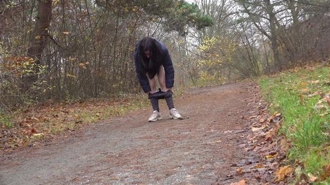 Brunette chick Helen takes a piss on a gravel path during a walk in the woods | Фото 2