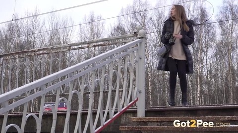 Caucasian female Valya takes a piss on snow-covered steps in public | Фото 1